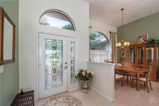 61 E Falconry Ct, Hernando, FL 34442 - foyer with a chandelier and light wood finished floors