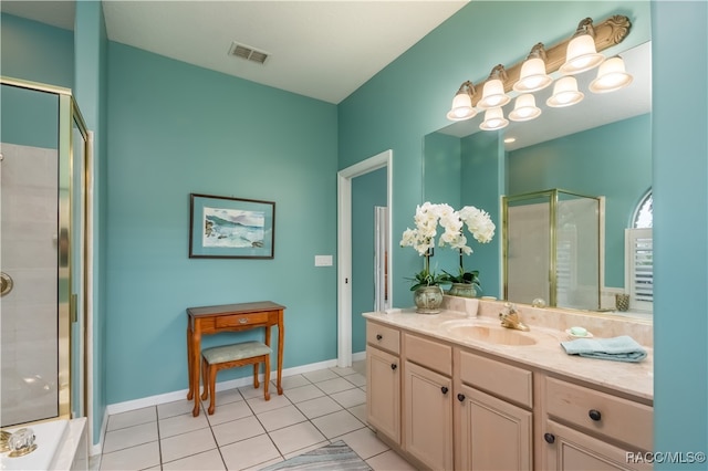 bathroom featuring tile patterned floors, vanity, and a shower with shower door