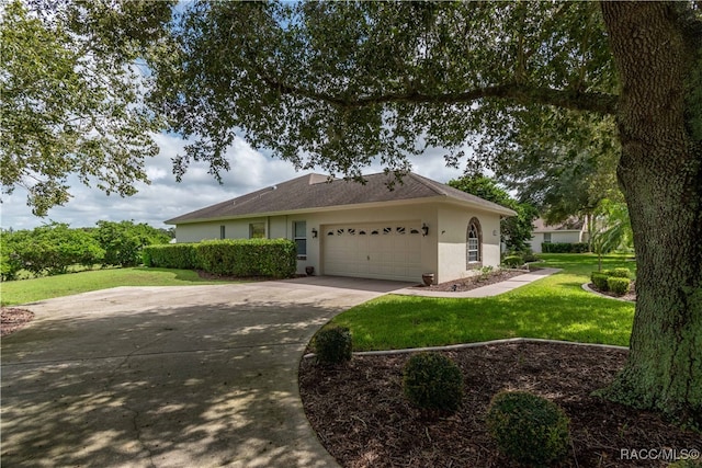 single story home with a garage and a front lawn