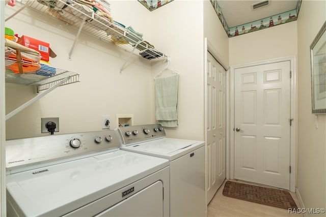 laundry room featuring separate washer and dryer