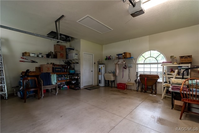 garage featuring electric water heater and a garage door opener