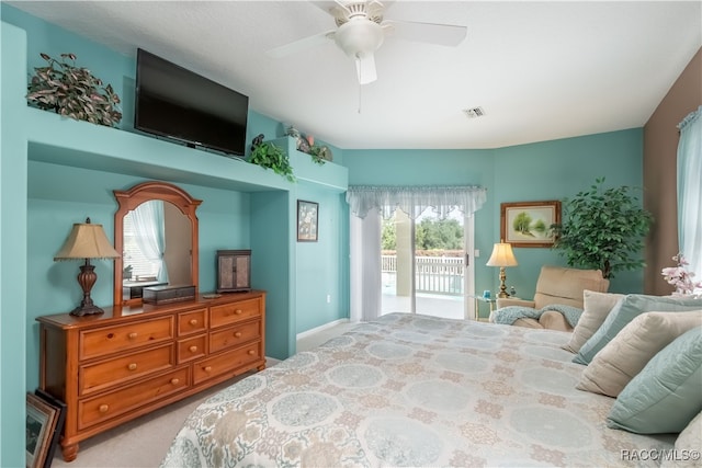 carpeted bedroom with ceiling fan, access to exterior, and multiple windows