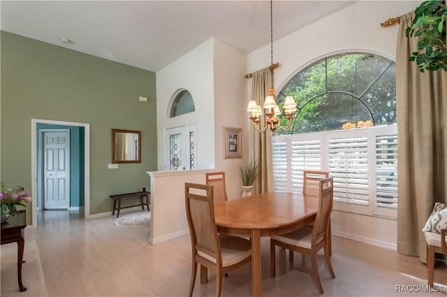 dining area featuring light hardwood / wood-style flooring and a notable chandelier