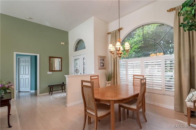 61 E Falconry Ct, Hernando, FL 34442 - dining room featuring high vaulted ceiling, a chandelier, and light wood-style flooring