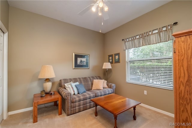 carpeted living room featuring ceiling fan