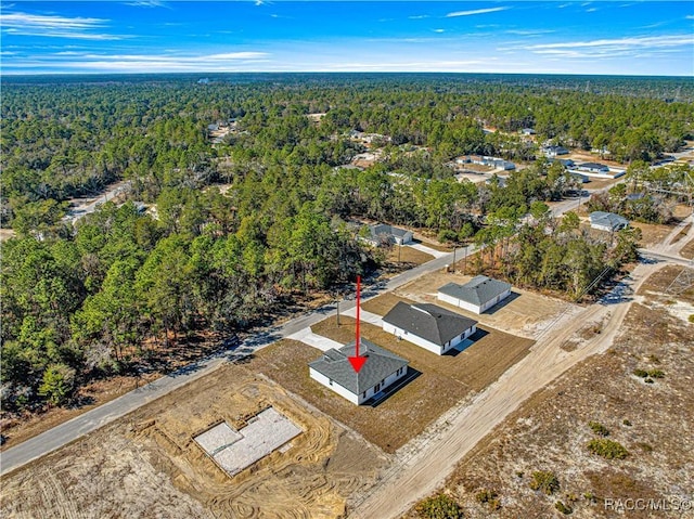 drone / aerial view featuring a view of trees