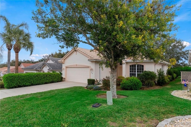 view of front of house with a tiled roof, concrete driveway, a front yard, stucco siding, and an attached garage