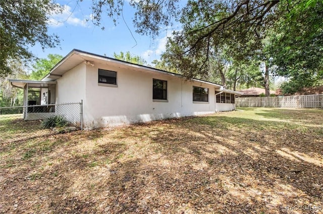1420 E Silver Thorn Loop, Hernando, FL 34442 - rear view of house with a fenced backyard and stucco siding
