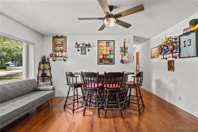 1420 E Silver Thorn Loop, Hernando, FL 34442 - dining area featuring a dry bar, wood finished floors, ceiling fan, a textured ceiling, and baseboards