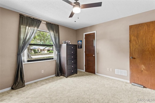 1420 E Silver Thorn Loop, Hernando, FL 34442 - unfurnished bedroom with carpet, baseboards, a ceiling fan, and a textured ceiling