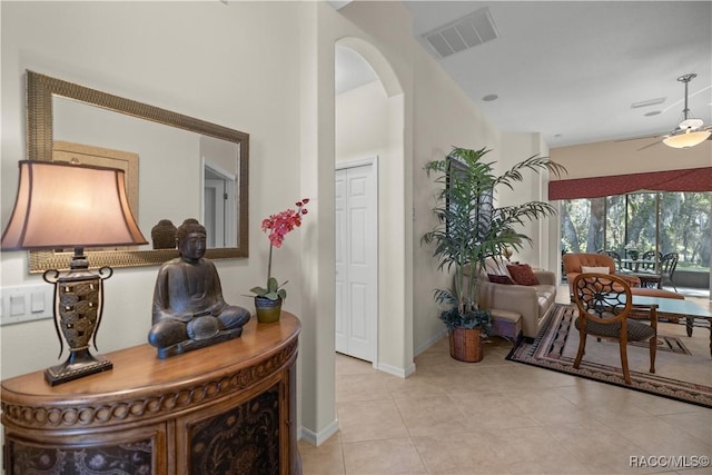 interior space featuring light tile patterned flooring and ceiling fan