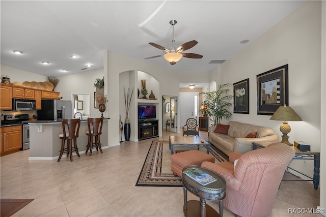 living room with light tile patterned floors and ceiling fan