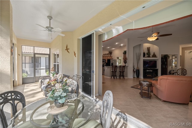 dining area with lofted ceiling and light tile patterned floors