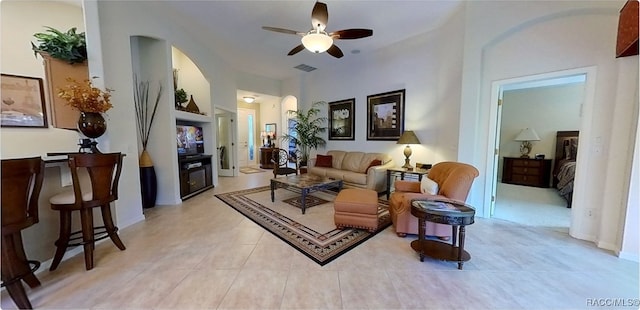 living room with ceiling fan and light tile patterned flooring