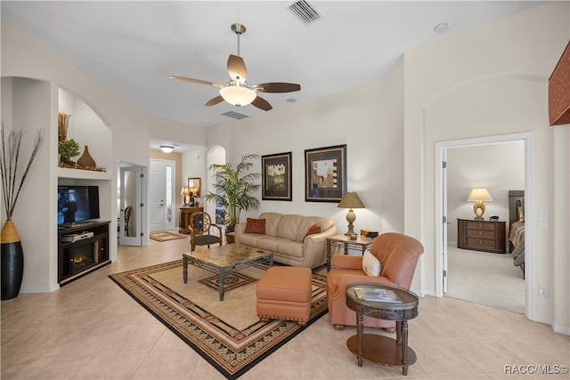 tiled living room featuring ceiling fan