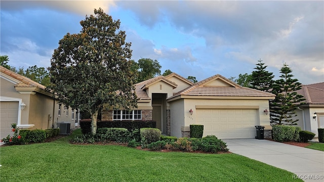 view of front of house with a front lawn, cooling unit, and a garage