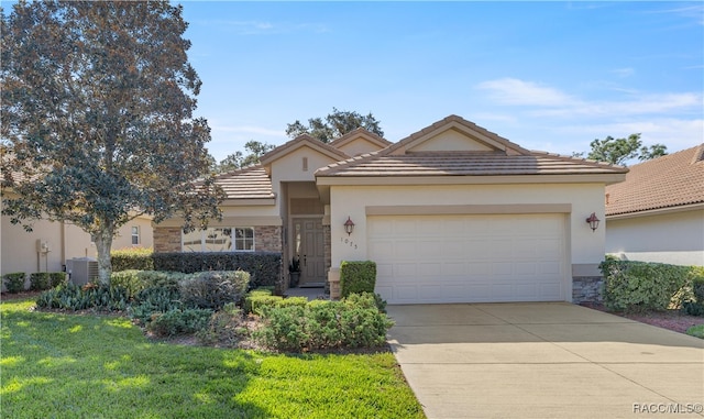 view of front of home featuring a garage, a front yard, and central AC unit