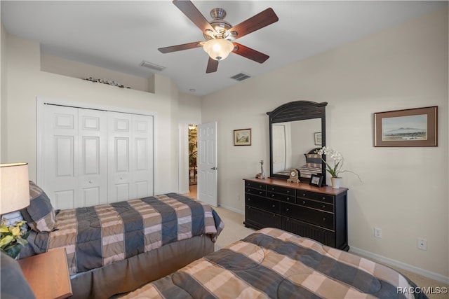 carpeted bedroom featuring ceiling fan and a closet