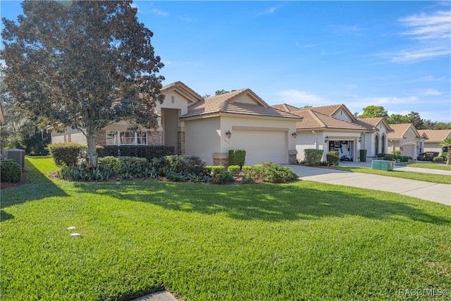 view of front of home with a garage, central air condition unit, and a front yard