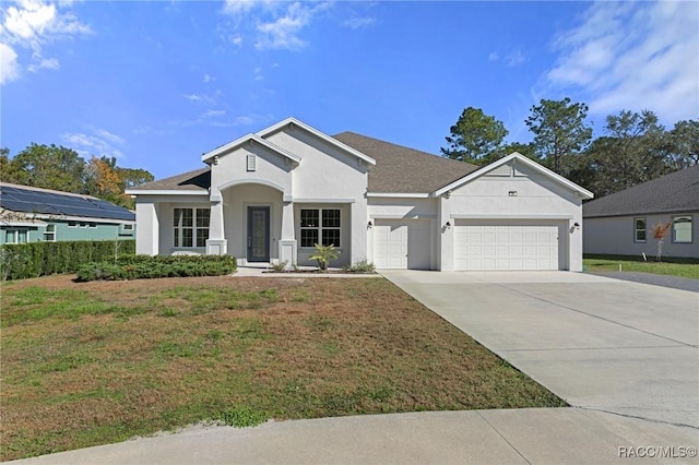 view of front facade with a front yard and a garage