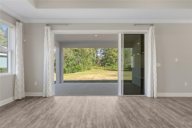 unfurnished room featuring hardwood / wood-style flooring and crown molding