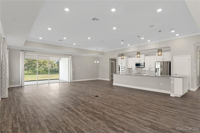 unfurnished living room with dark hardwood / wood-style flooring and crown molding