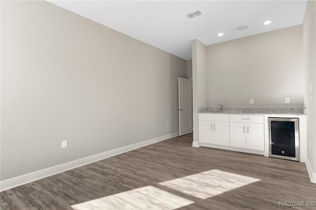 bar featuring white cabinets, dark hardwood / wood-style floors, sink, and wine cooler