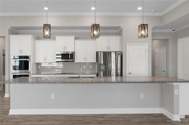 kitchen featuring white cabinets, appliances with stainless steel finishes, and a spacious island