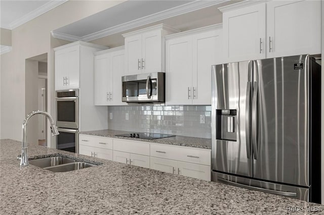 kitchen with light stone counters, sink, white cabinets, and appliances with stainless steel finishes