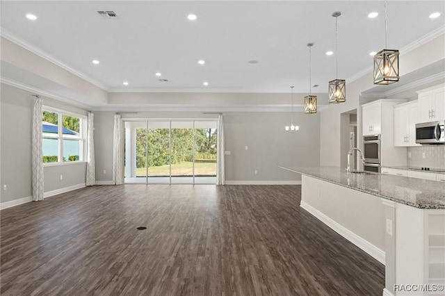 unfurnished living room featuring crown molding, dark hardwood / wood-style flooring, and sink