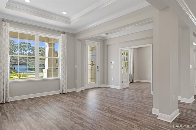 spare room featuring hardwood / wood-style floors, crown molding, and a tray ceiling