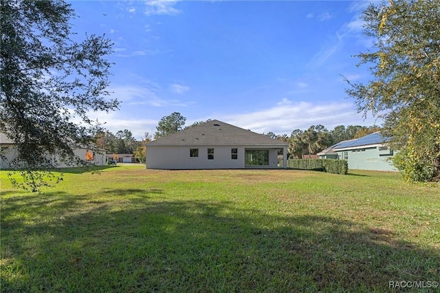 back of house featuring a yard