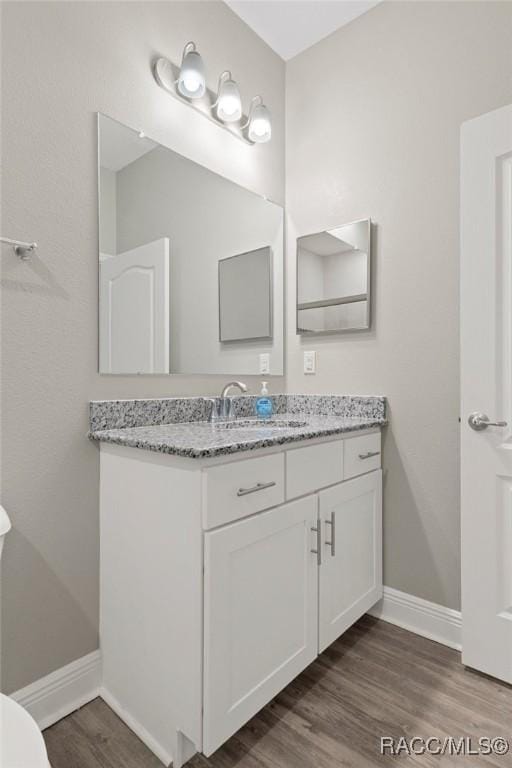 bathroom with vanity and hardwood / wood-style flooring