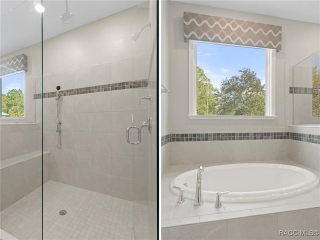 bathroom featuring plenty of natural light and plus walk in shower