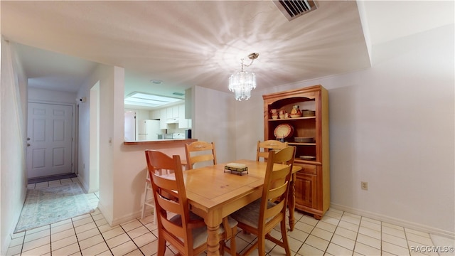 dining room with light tile patterned flooring and a notable chandelier