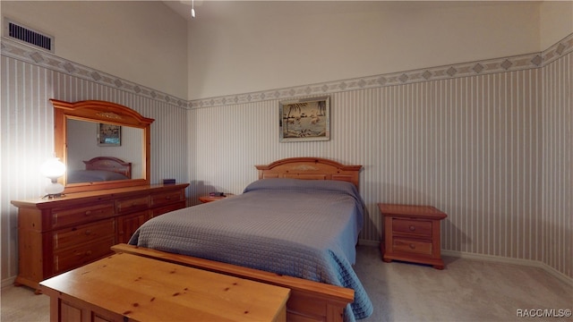 carpeted bedroom featuring high vaulted ceiling