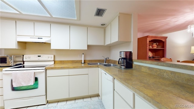 kitchen featuring white appliances, an inviting chandelier, white cabinets, sink, and light tile patterned floors