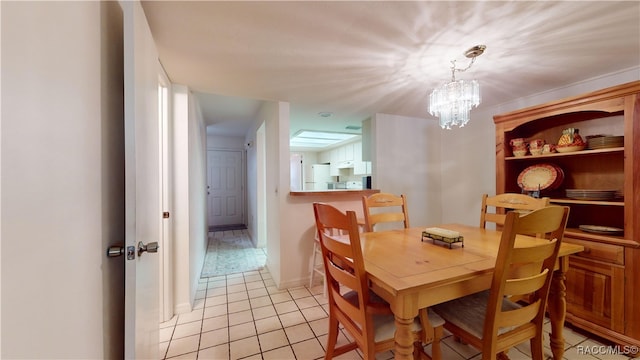 dining space featuring light tile patterned floors and a chandelier