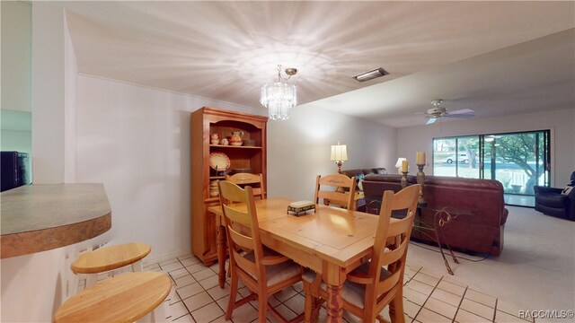 dining room with light tile patterned floors, ceiling fan with notable chandelier, and a baseboard heating unit