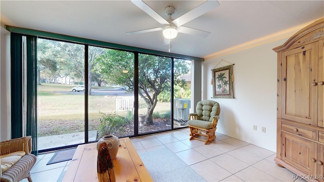 sitting room featuring light tile patterned flooring, floor to ceiling windows, and ceiling fan