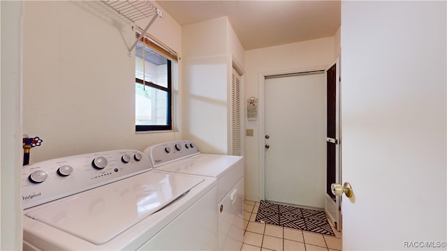 laundry room with washing machine and dryer and light tile patterned flooring