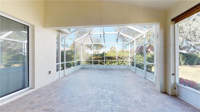 unfurnished sunroom with vaulted ceiling