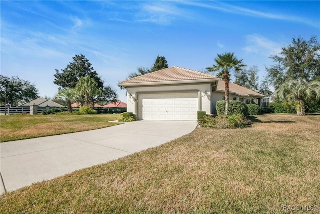 view of front of home featuring a garage and a front lawn