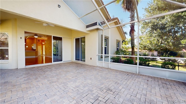 unfurnished sunroom featuring vaulted ceiling and ceiling fan