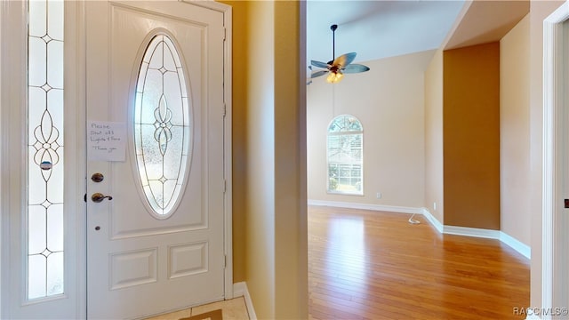 entrance foyer featuring ceiling fan, a healthy amount of sunlight, and light hardwood / wood-style floors