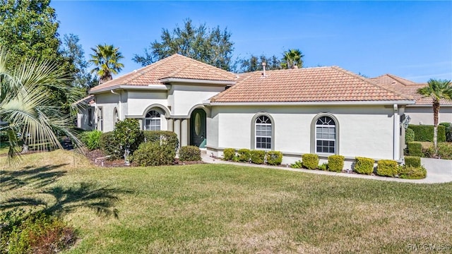 mediterranean / spanish-style home featuring a front lawn