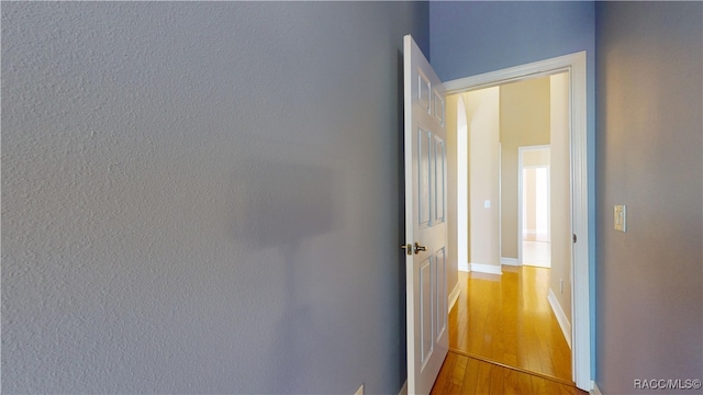 corridor with wood-type flooring