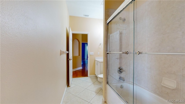 full bathroom with toilet, shower / bath combination with glass door, tile patterned floors, and vanity