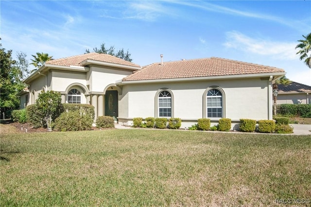 mediterranean / spanish-style house featuring a front yard