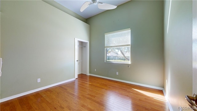 unfurnished room with ceiling fan, light hardwood / wood-style flooring, and vaulted ceiling